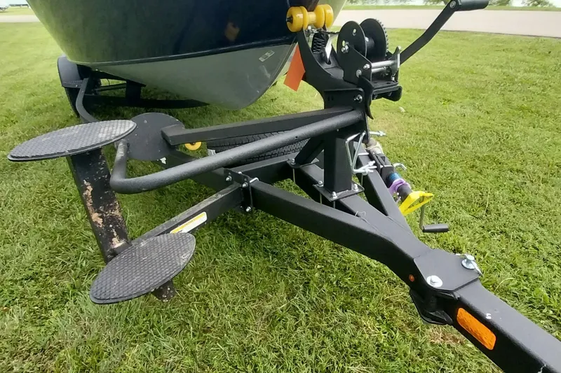 Slide: The Image of 2024 Tracker Targa V-18 Combo boat trailer on grass, showcasing sturdy construction. - 25