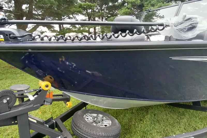 Slide: The Image of 2024 Tracker Targa V-18 Combo boat on trailer, parked on grass. - 27
