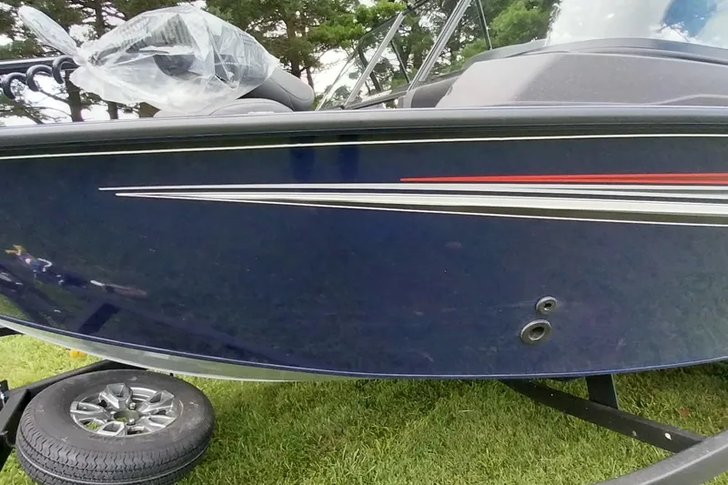 Slide: The Image of 2024 Tracker Targa V-18 Combo boat with sleek design and vibrant stripes on display. - 28