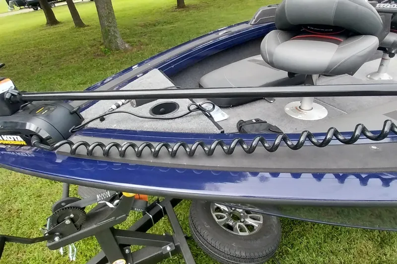 Slide: The Image of 2024 Tracker Targa V-18 Combo boat with trolling motor and seating on grassy area. - 30