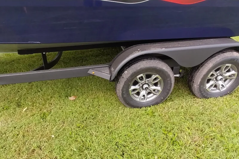 Slide: The Image of Trailer wheels of 2024 Tracker Targa V-18 Combo on grass. - 35