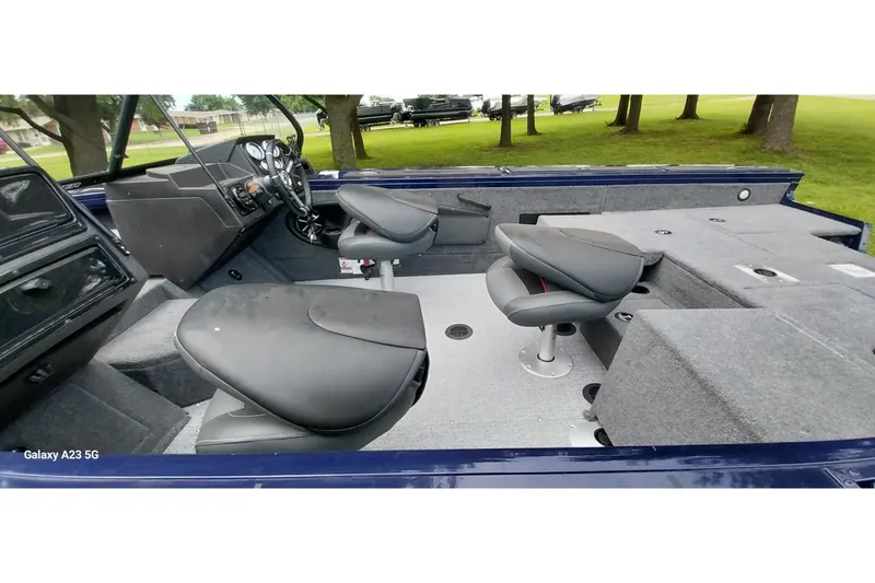 Slide: The Image of 2024 Tracker Targa V-18 Combo boat interior with seating and dashboard view. - 37