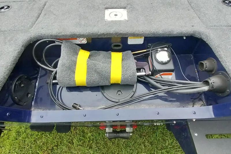 Slide: The Image of 2024 Tracker Targa V-18 Combo boat storage compartment with cables and equipment. - 4