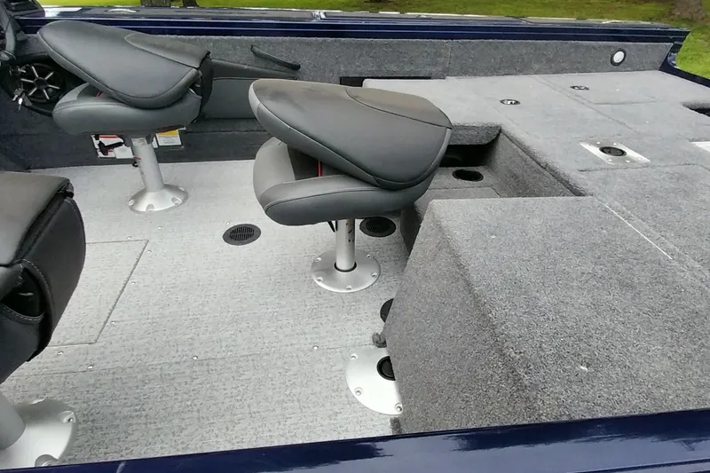 Slide: The Image of 2024 Tracker Targa V-18 Combo boat interior with gray seating and carpeted flooring. - 40