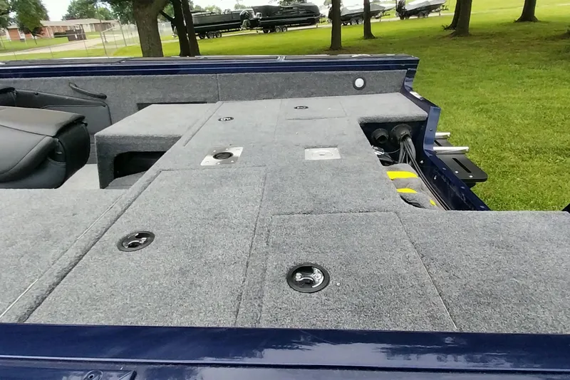 Slide: The Image of 2024 Tracker Targa V-18 Combo boat interior with carpeted deck and storage compartments. - 43