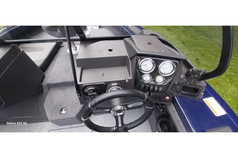 Slide: The Image of 2024 Tracker Targa V-18 Combo boat dashboard with steering wheel and gauges. - 46