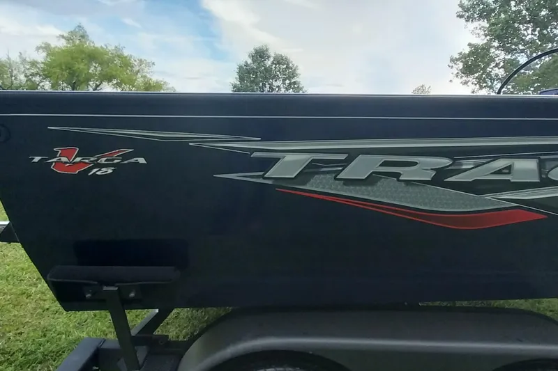 Slide: The Image of 2024 Tracker Targa V-18 Combo boat side view with logo and graphics. - 5
