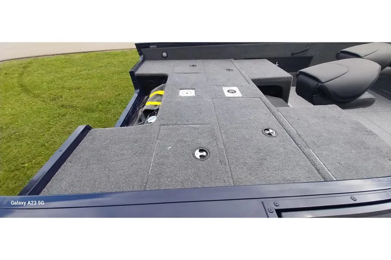 Slide: The Image of 2024 Tracker Targa V-18 Combo boat interior with carpeted deck and seating. - 9
