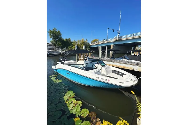The Image of 2022 Sea Ray SPX 230 Outboard boat docked near a bridge on a sunny day. - 1