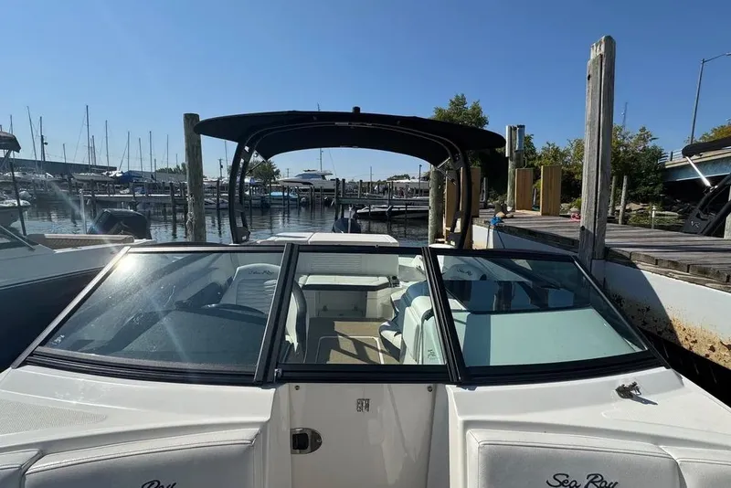 Slide: The Image of 2022 Sea Ray SPX 230 Outboard boat docked at marina under clear sky. - 10