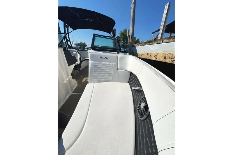 Slide: The Image of 2022 Sea Ray SPX 230 Outboard boat interior with white seating and sleek design. - 13