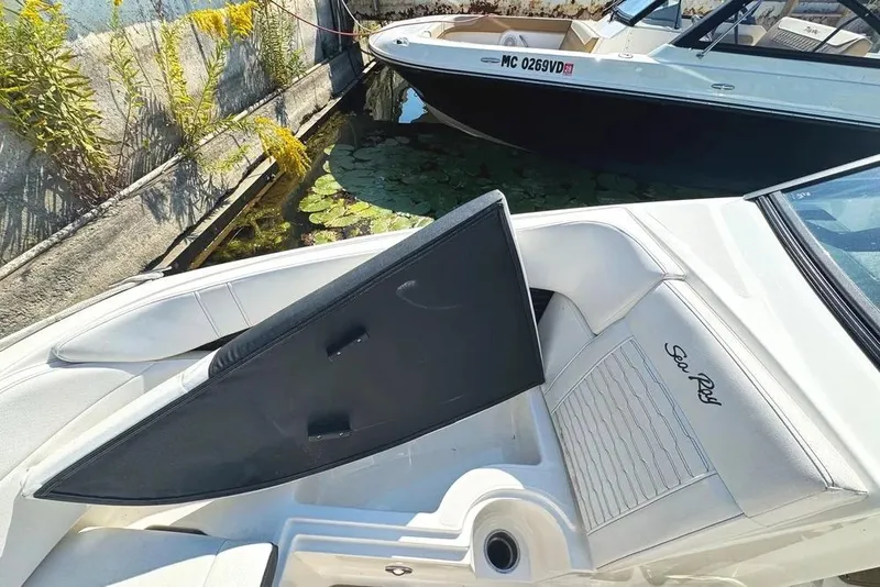 Slide: The Image of 2022 Sea Ray SPX 230 Outboard boat with sleek white seating and stylish design. - 15