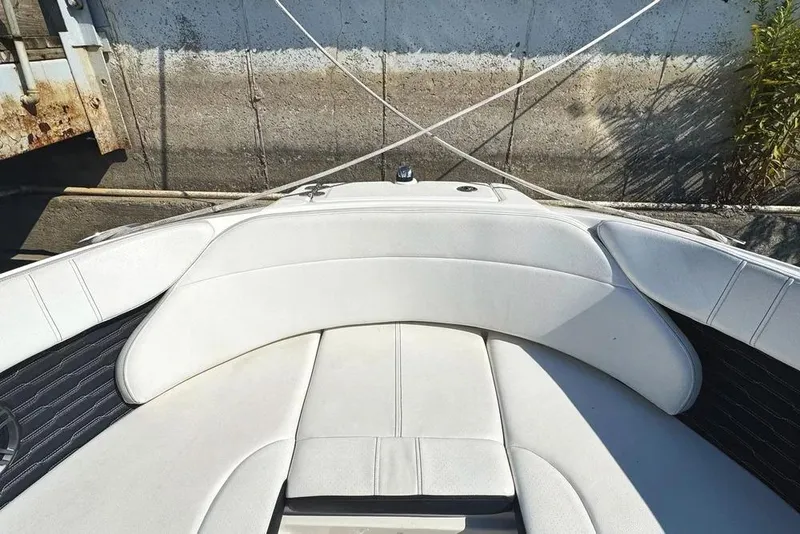 Slide: The Image of 2022 Sea Ray SPX 230 Outboard boat with white cushioned seating. - 16