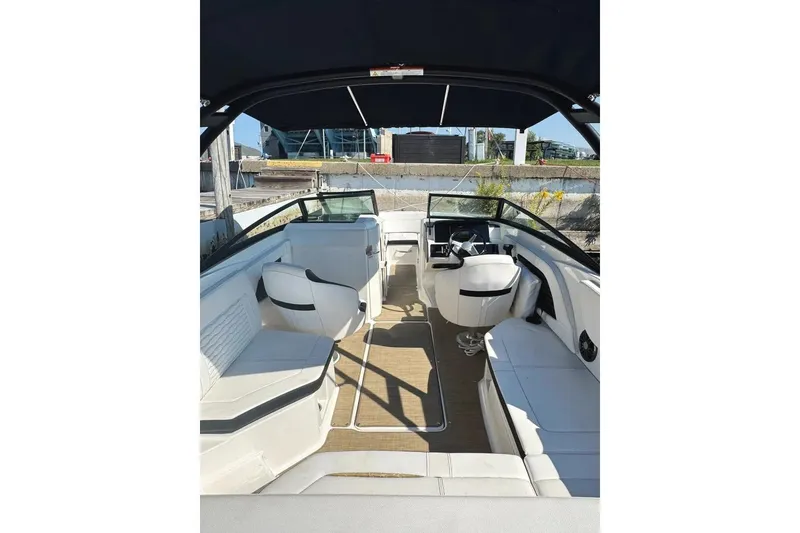 Slide: The Image of 2022 Sea Ray SPX 230 Outboard boat interior with seating and steering wheel. - 2