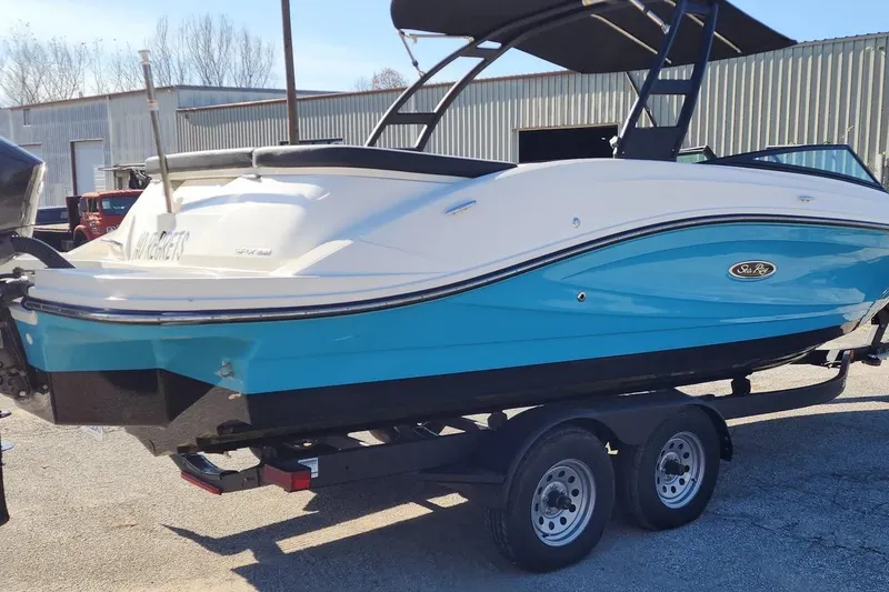 Slide: The Image of 2022 Sea Ray SPX 230 Outboard boat on trailer, blue and white design. - 29