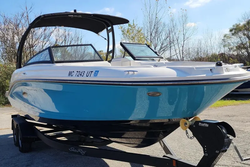 Slide: The Image of 2022 Sea Ray SPX 230 Outboard boat on trailer, blue and white design, sunny day. - 37