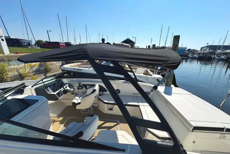 Slide: The Image of 2022 Sea Ray SPX 230 Outboard boat docked at a marina under clear blue skies. - 40