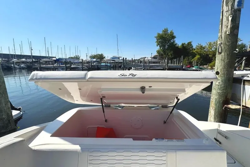Slide: The Image of 2022 Sea Ray SPX 230 Outboard boat storage compartment open at marina. - 43