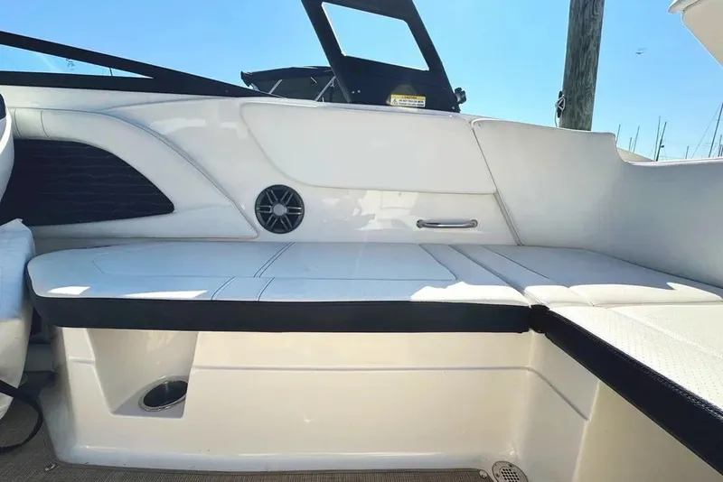 Slide: The Image of 2022 Sea Ray SPX 230 Outboard interior seating with sleek white upholstery. - 44