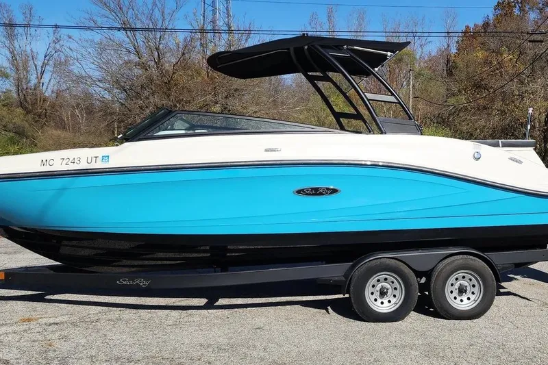 Slide: The Image of 2022 Sea Ray SPX 230 Outboard boat on trailer, blue and white design. - 46