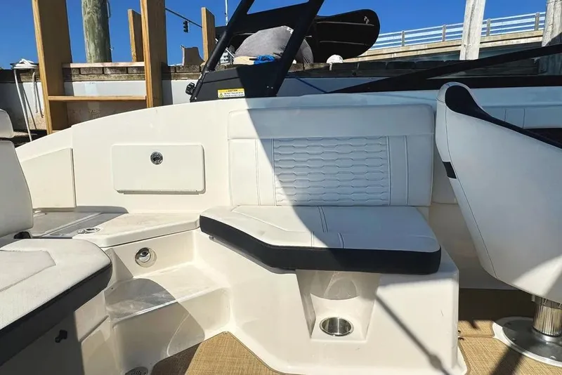 Slide: The Image of 2022 Sea Ray SPX 230 Outboard interior with white seating and modern design. - 47