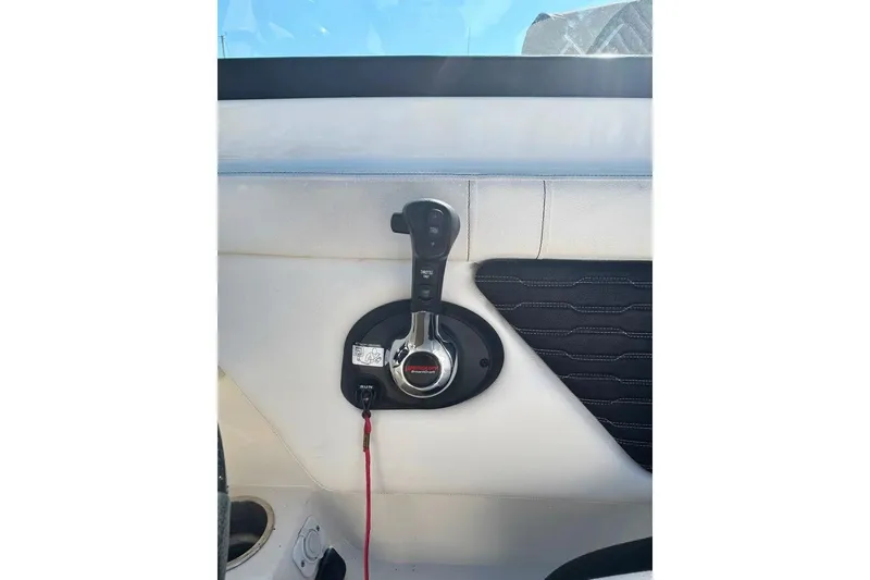 Slide: The Image of 2022 Sea Ray SPX 230 Outboard throttle control on white interior panel. - 6