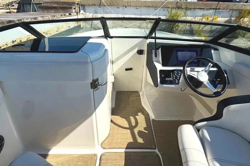 Slide: The Image of 2022 Sea Ray SPX 230 Outboard boat interior with steering wheel and dashboard. - 9