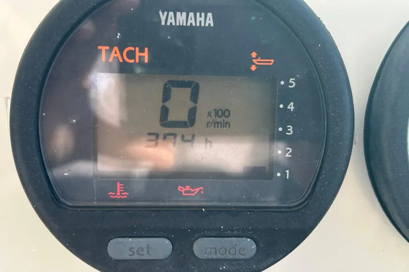Slide: The Image of Yamaha tachometer displaying 0 RPM and 374 hours on a Pursuit 2470 Walkaround boat. - 14
