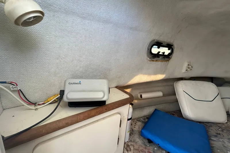 Slide: The Image of Interior of a 2000 Pursuit 2470 Walkaround boat with Garmin device and seating. - 19