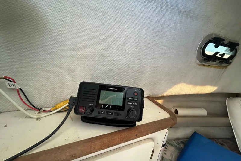 Slide: The Image of Garmin marine radio inside 2000 Pursuit 2470 Walkaround boat cabin, near small window. - 20