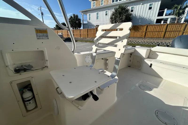 Slide: The Image of 2000 Pursuit 2470 Walkaround boat interior with seating and storage compartments. - 23
