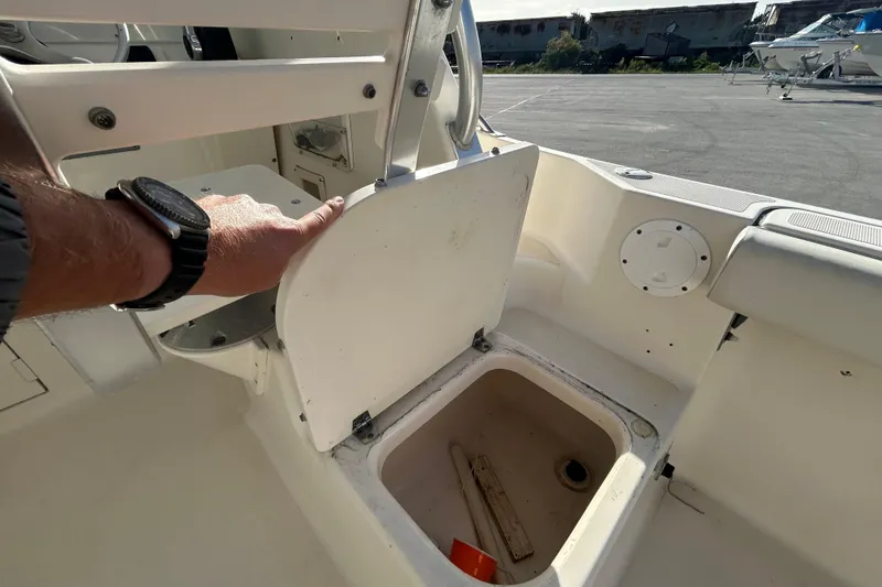 Slide: The Image of 2000 Pursuit 2470 Walkaround boat interior with storage compartment open. - 26