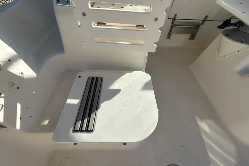Slide: The Image of 2000 Pursuit 2470 Walkaround boat interior with seating and storage compartments. - 27