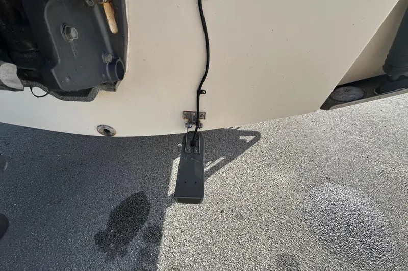 Slide: The Image of 2000 Pursuit 2470 Walkaround boat transom with mounted sensor on pavement. - 6