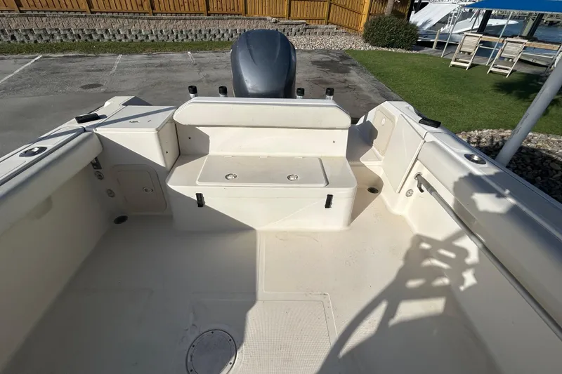 Slide: The Image of 2000 Pursuit 2470 Walkaround boat interior with seating and storage compartments. - 7