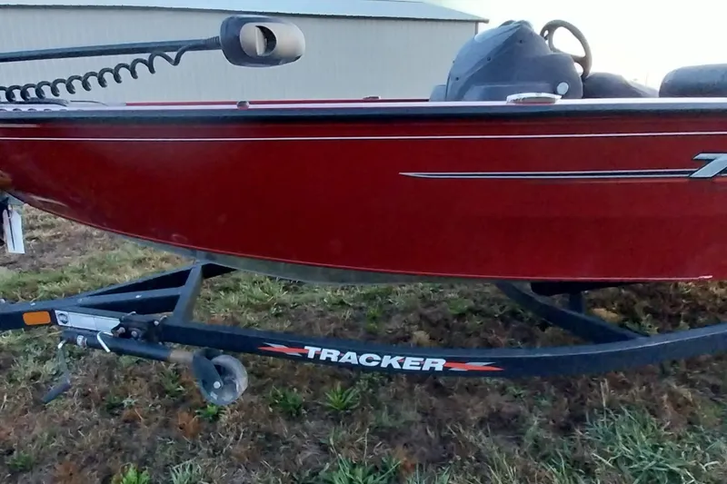 Slide: The Image of 2021 Tracker Super Guide V-16 SC boat on trailer, red exterior, side view. - 13