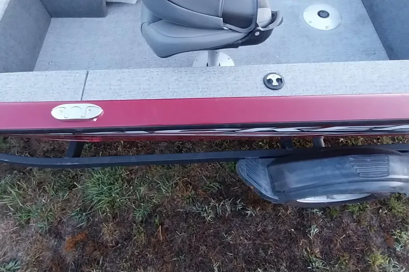 Slide: The Image of 2021 Tracker Super Guide V-16 SC boat on trailer, red exterior, gray interior. - 17