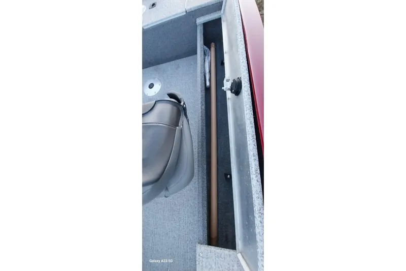 Slide: The Image of 2021 Tracker Super Guide V-16 SC boat interior with storage compartment and seat. - 22