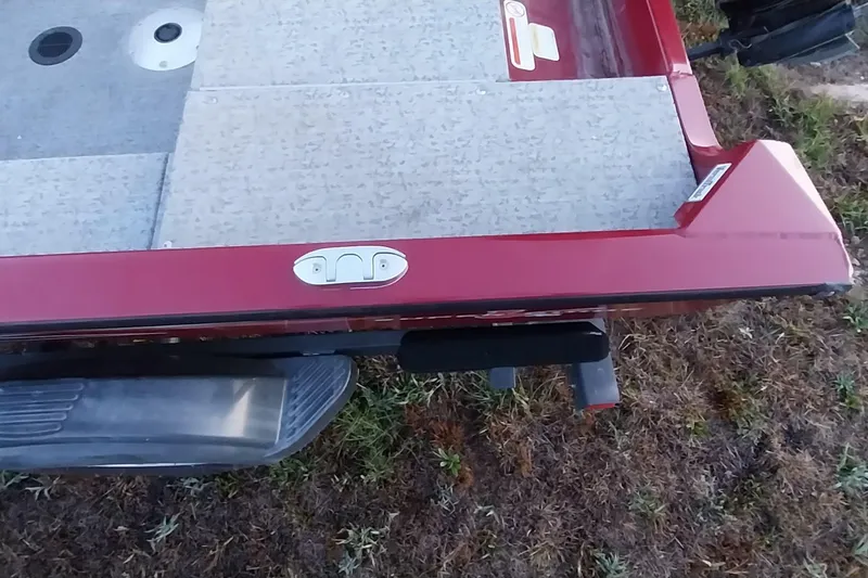 Slide: The Image of Red Tracker Super Guide V-16 SC boat, 2021 model, on grassy ground. - 26