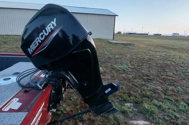 Slide: The Image of 2021 Tracker Super Guide V-16 SC with Mercury outboard motor in grassy area. - 30