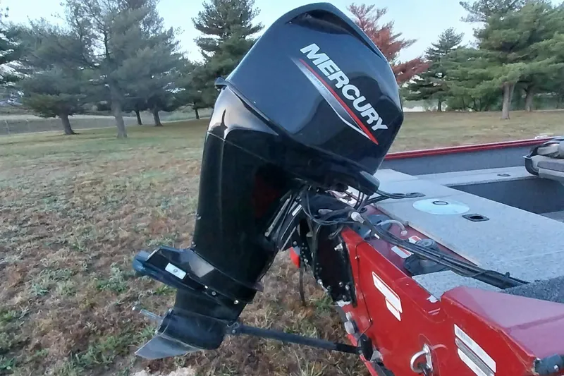 Slide: The Image of 2021 Tracker Super Guide V-16 SC boat with Mercury outboard motor in a grassy area. - 31