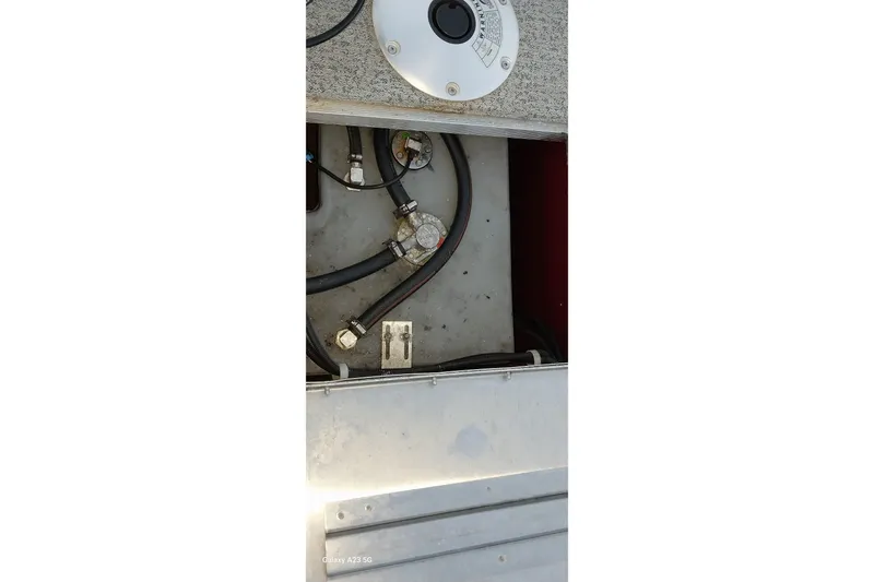 Slide: The Image of 2021 Tracker Super Guide V-16 SC boat interior showing fuel system components and wiring. - 35