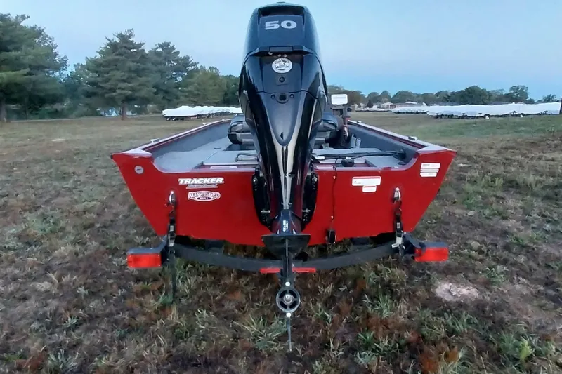 Slide: The Image of 2021 Tracker Super Guide V-16 SC boat with outboard motor, parked on grass. - 39