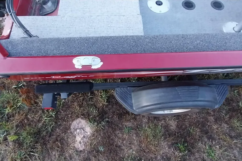 Slide: The Image of Red 2021 Tracker Super Guide V-16 SC boat on trailer, grassy background. - 42