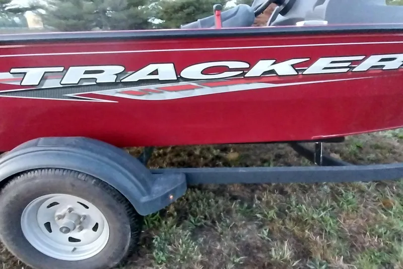 Slide: The Image of 2021 Tracker Super Guide V-16 SC boat on trailer, red exterior. - 44