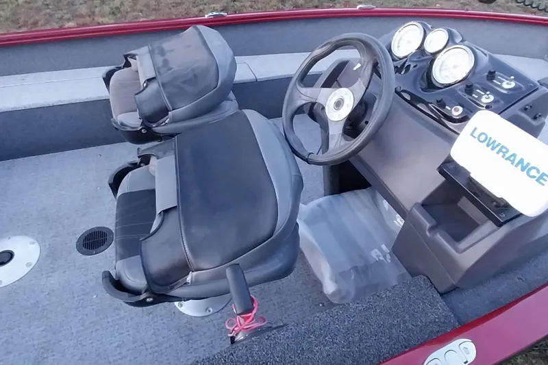 Slide: The Image of 2021 Tracker Super Guide V-16 SC boat interior with steering wheel and seats. - 48