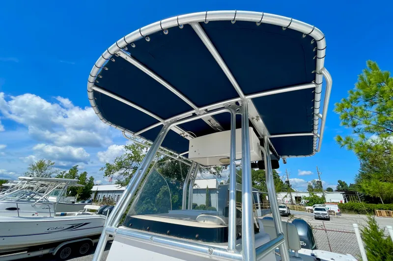 Slide: The Image of 2004 Grady-White Advance 257 boat with blue canopy under clear sky. - 12