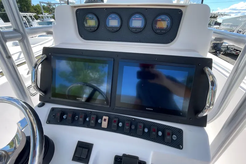 Slide: The Image of Control panel of 2004 Grady-White Advance 257 boat with Garmin displays and gauges. - 17