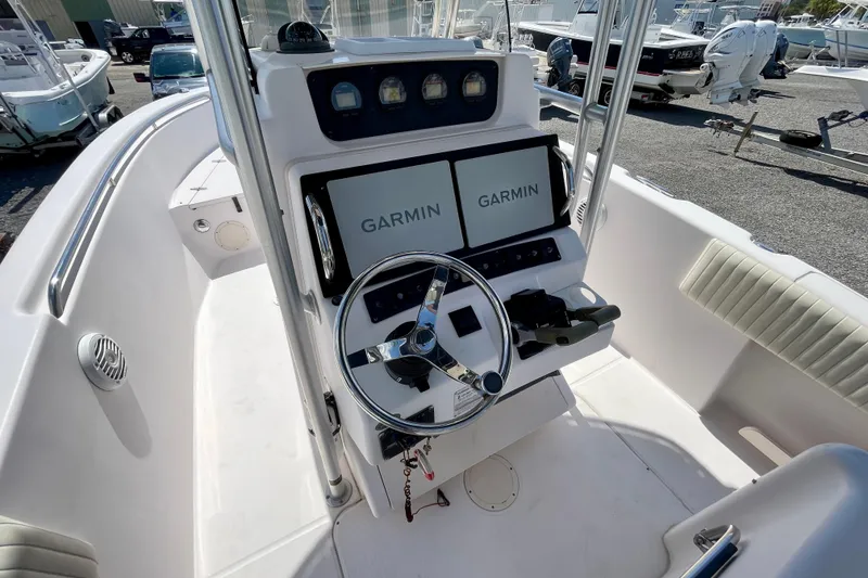 Slide: The Image of 2004 Grady-White Advance 257 boat cockpit with Garmin navigation displays. - 18
