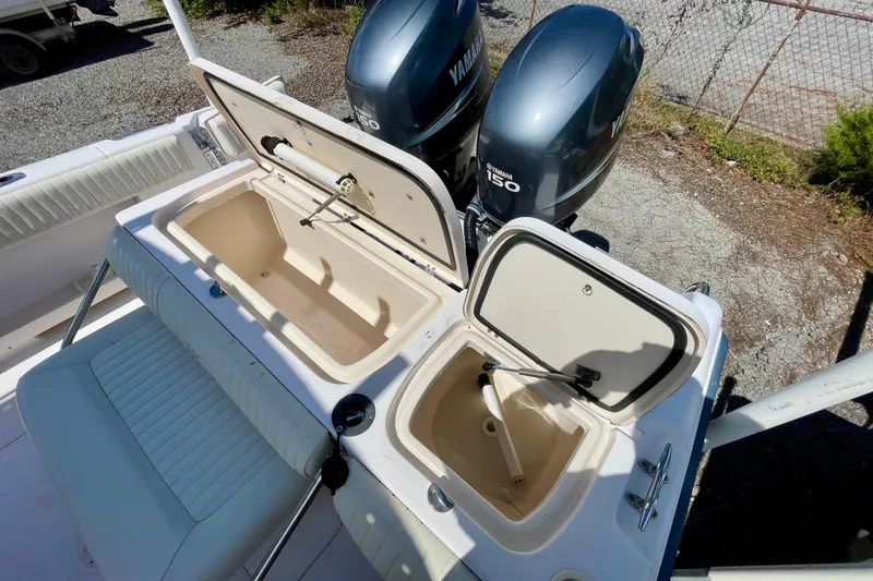 Slide: The Image of 2004 Grady-White Advance 257 boat with Yamaha 150 engines and open storage compartments. - 21